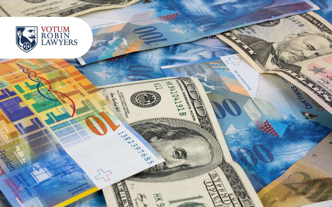 Votum Robin Lawyers logo on a collage of US dollars and other currencies, suggesting financial settlements/s legal finance.