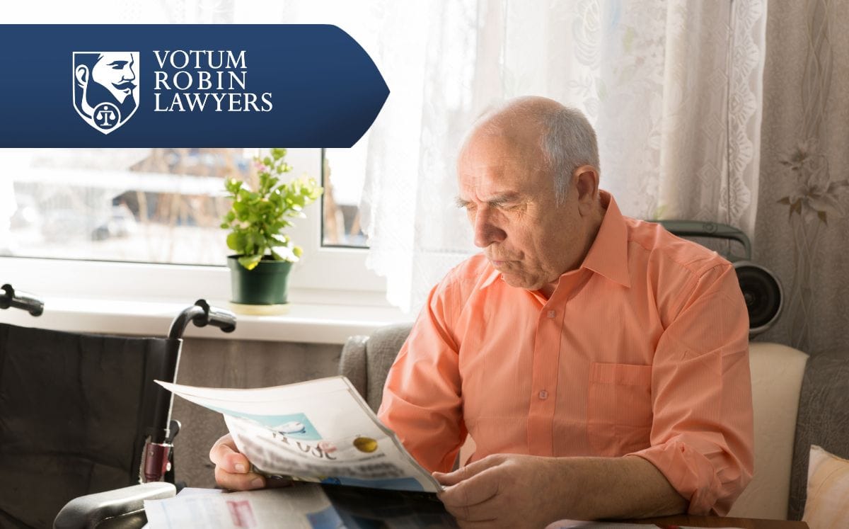 Two lawyers in suits review documents on a desk with a gavel and scales of justice; law firm logo in the corner.
