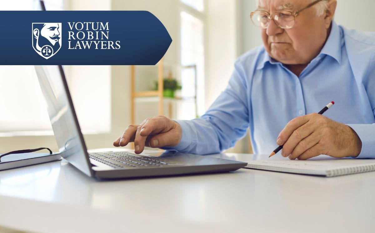 Two lawyers in suits review documents on a desk with a gavel and scales of justice; law firm logo in the corner.